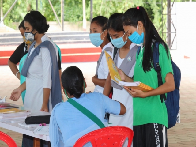 Class 10 students collecting copies