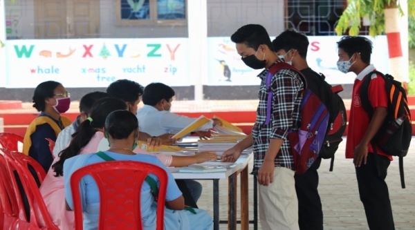 Class X students collecting their copies and interecting with their teachers.